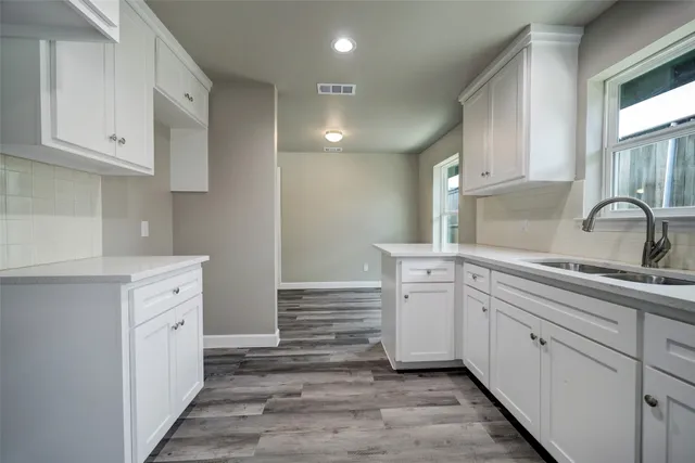 a kitchen with white cabinets and white appliances