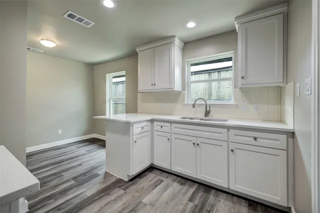 a spacious bathroom with a double vanity sink a mirror and window
