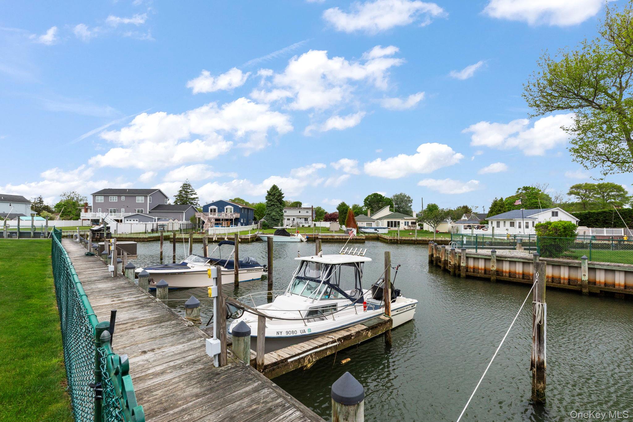 248 Mariners Way Copiague, NY 11726 - Photo 12 of 18 a view of a lake with chairs