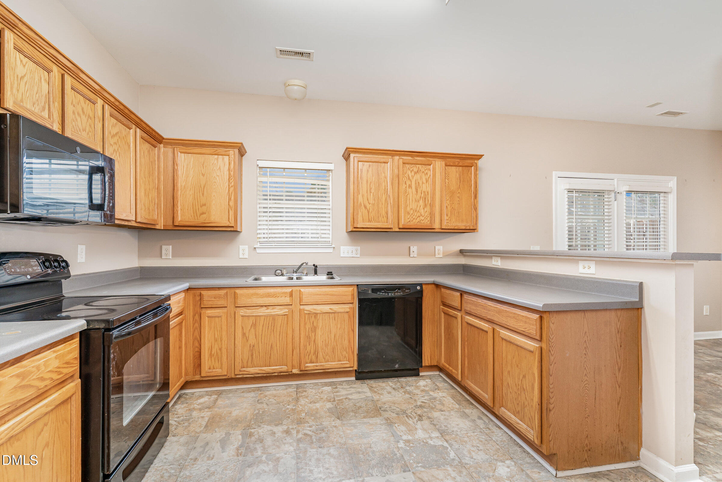 3531 Oneonta Avenue Raleigh, NC 27604 - Photo 15 of 32 a kitchen with stainless steel appliances granite countertop a stove sink and cabinets