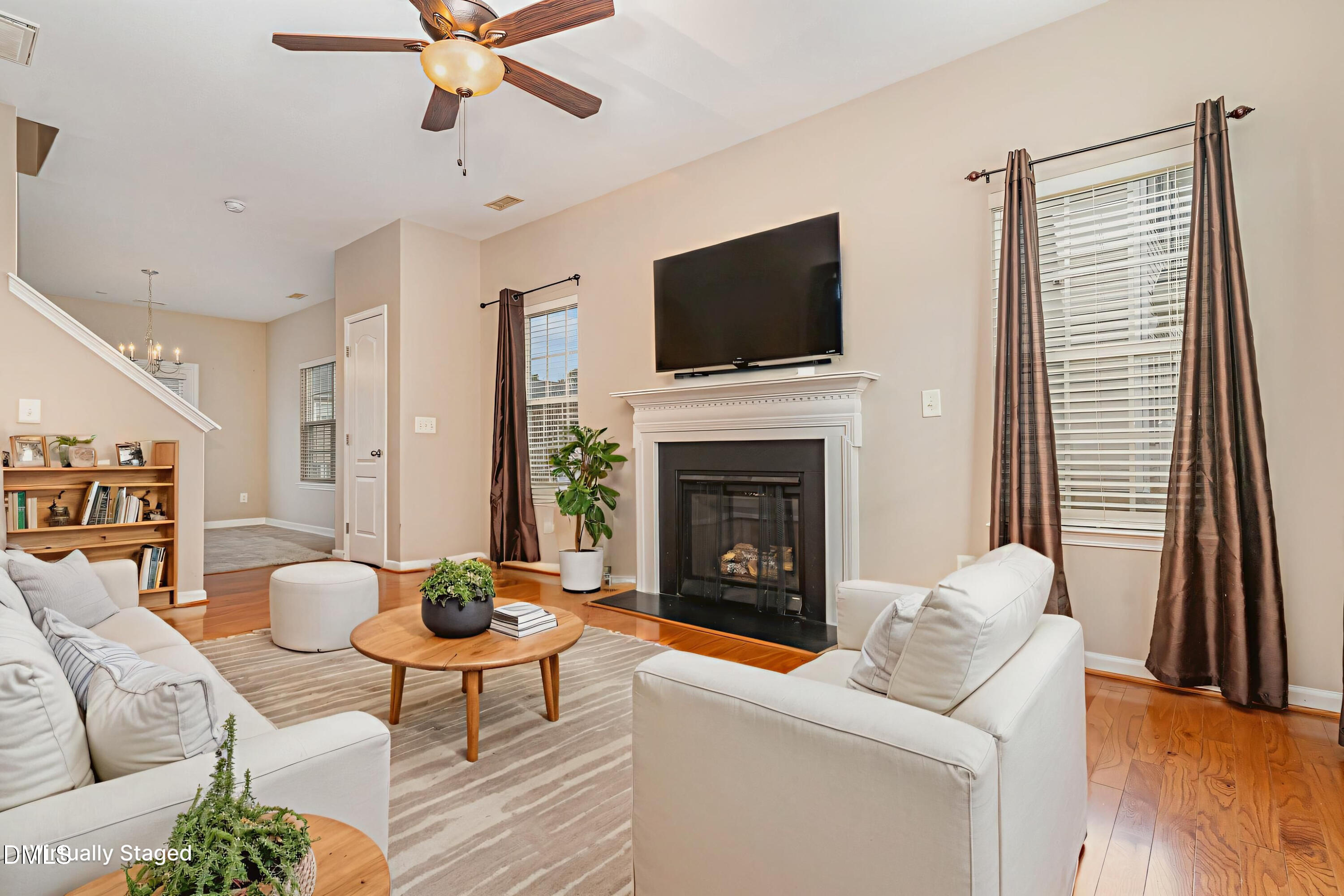 3531 Oneonta Avenue Raleigh, NC 27604 - Photo 6 of 32 a living room with furniture a flat screen tv and a fireplace