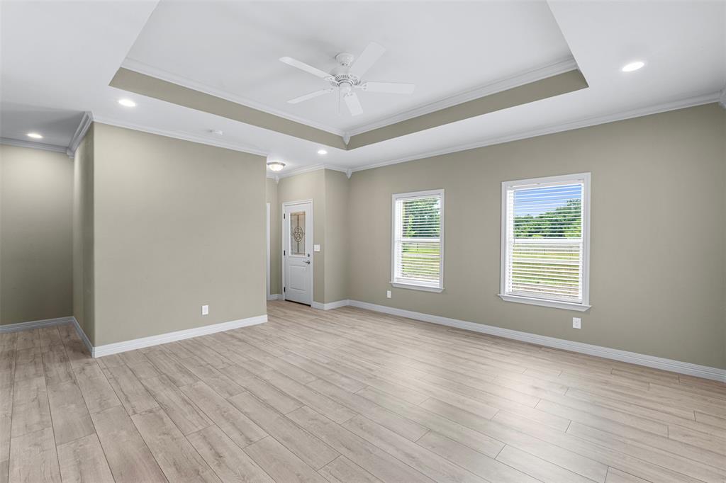 1011 Southeast County Road Corsicana, TX 75109 - Photo 9 of 40 a view of an empty room with wooden floor and a window