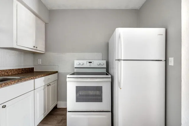 a white refrigerator freezer sitting inside of a kitchen