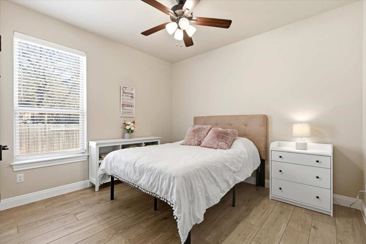 304 Morning Ridge Georgetown, TX 78628 - Photo 23 of 31 Bedroom featuring light wood-style flooring and ceiling fan