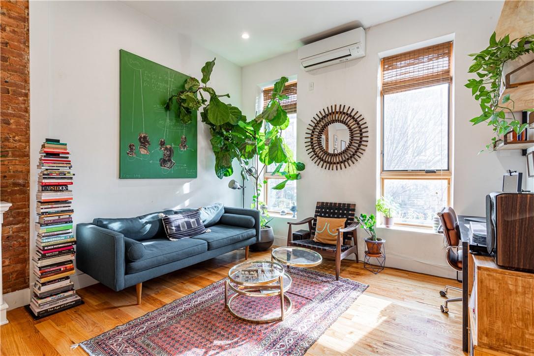 a living room with furniture a rug and a window