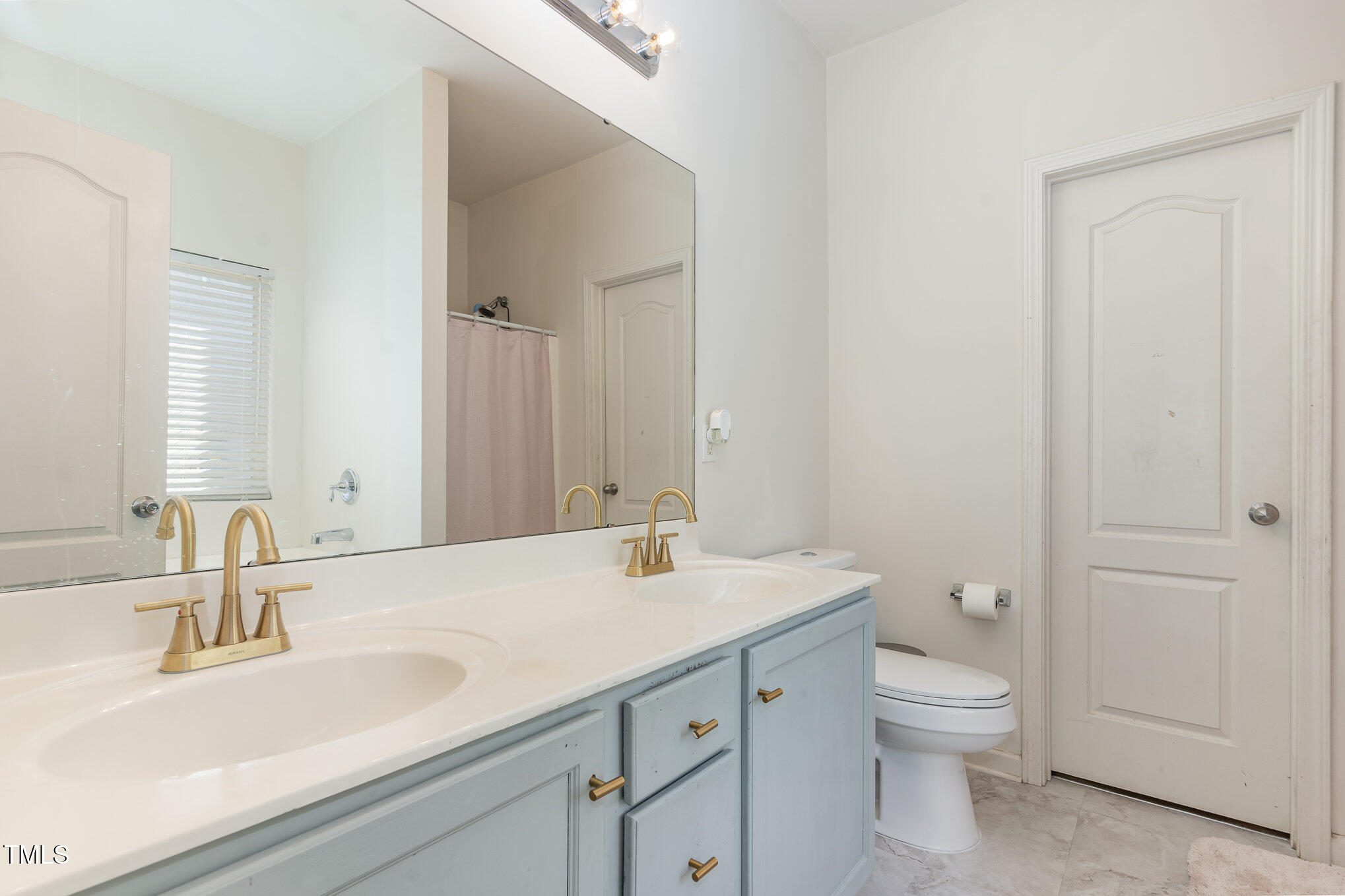 5627 Quitman Trail Raleigh, NC 27610 - Photo 12 of 26 a bathroom with a sink a toilet and a mirror