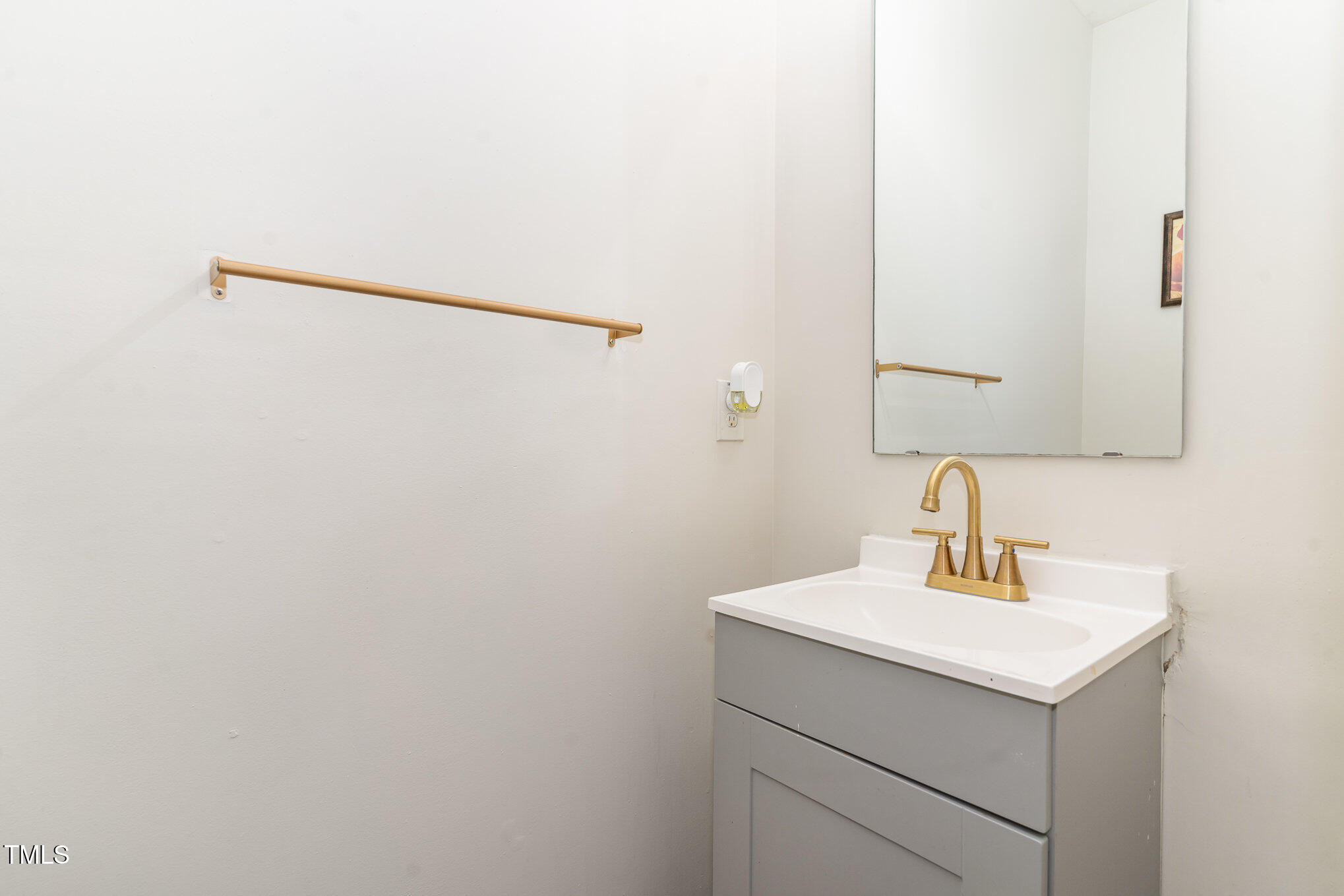 5627 Quitman Trail Raleigh, NC 27610 - Photo 15 of 26 a bathroom with a sink and mirror