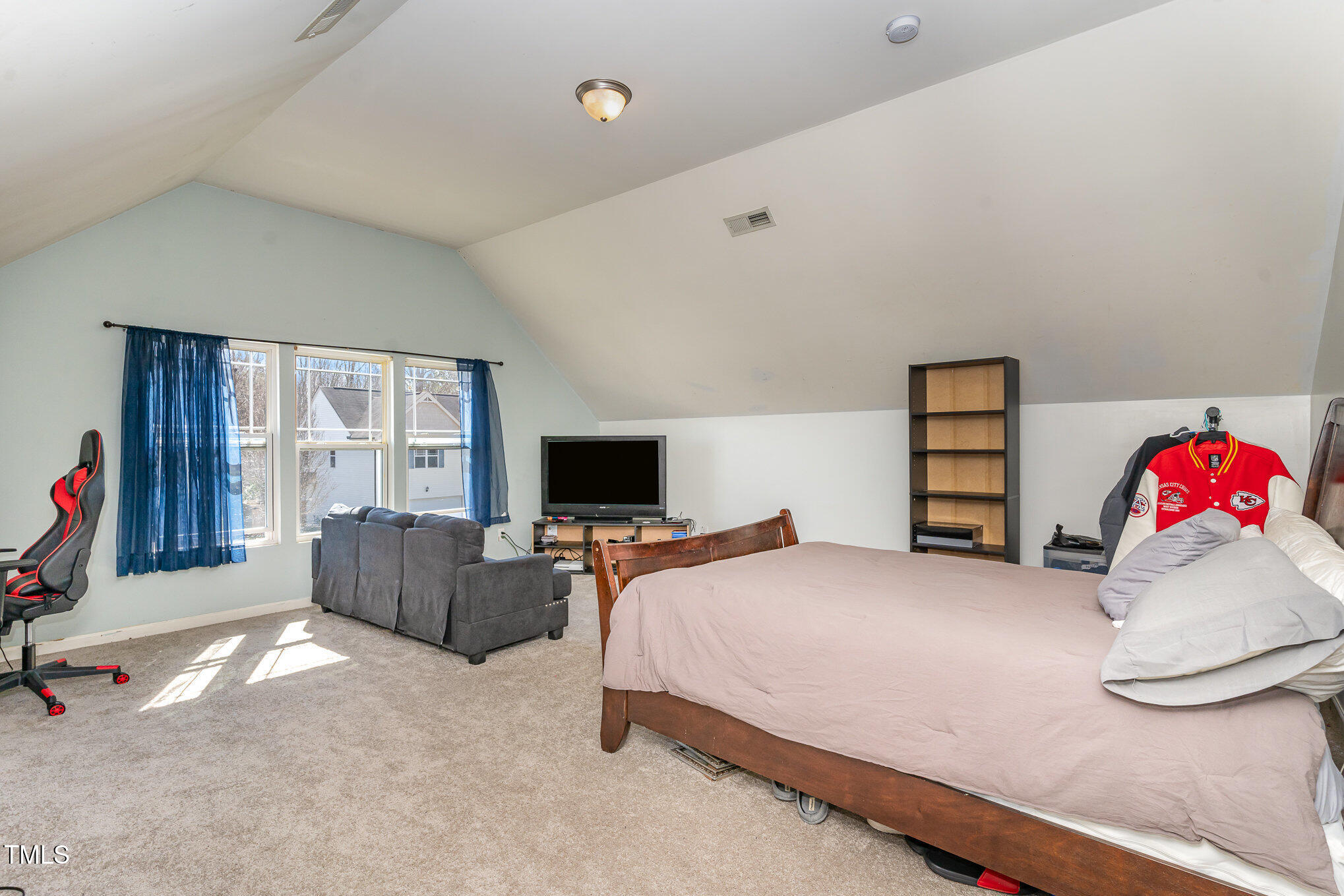 5627 Quitman Trail Raleigh, NC 27610 - Photo 18 of 26 a bedroom with a bed and flat screen tv