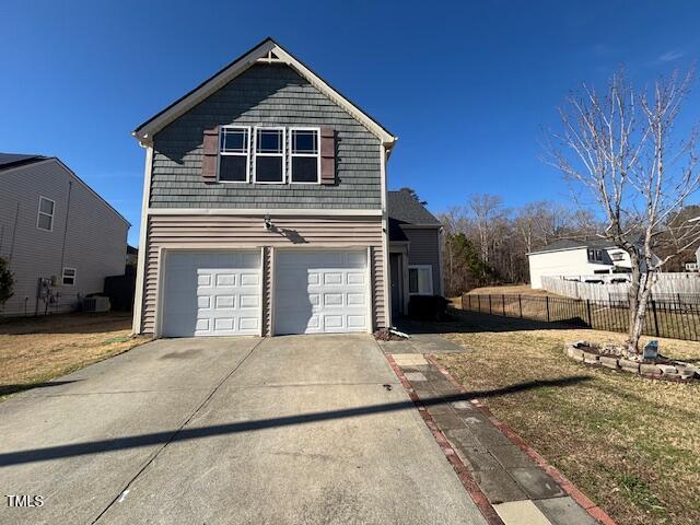 5627 Quitman Trail Raleigh, NC 27610 - Photo 25 of 26 a front view of a house with a garage