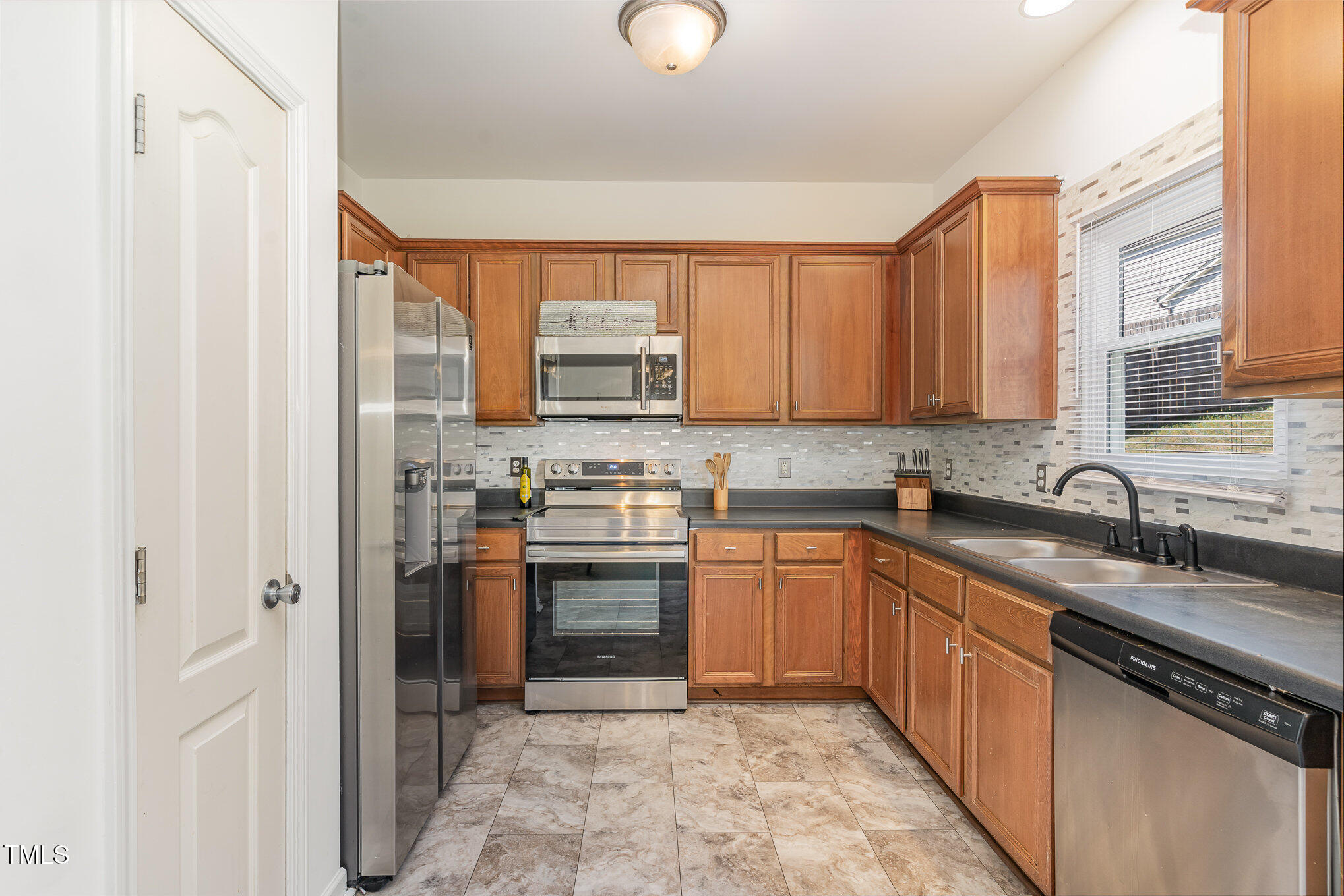 5627 Quitman Trail Raleigh, NC 27610 - Photo 6 of 26 a kitchen with stainless steel appliances granite countertop a sink stove and refrigerator