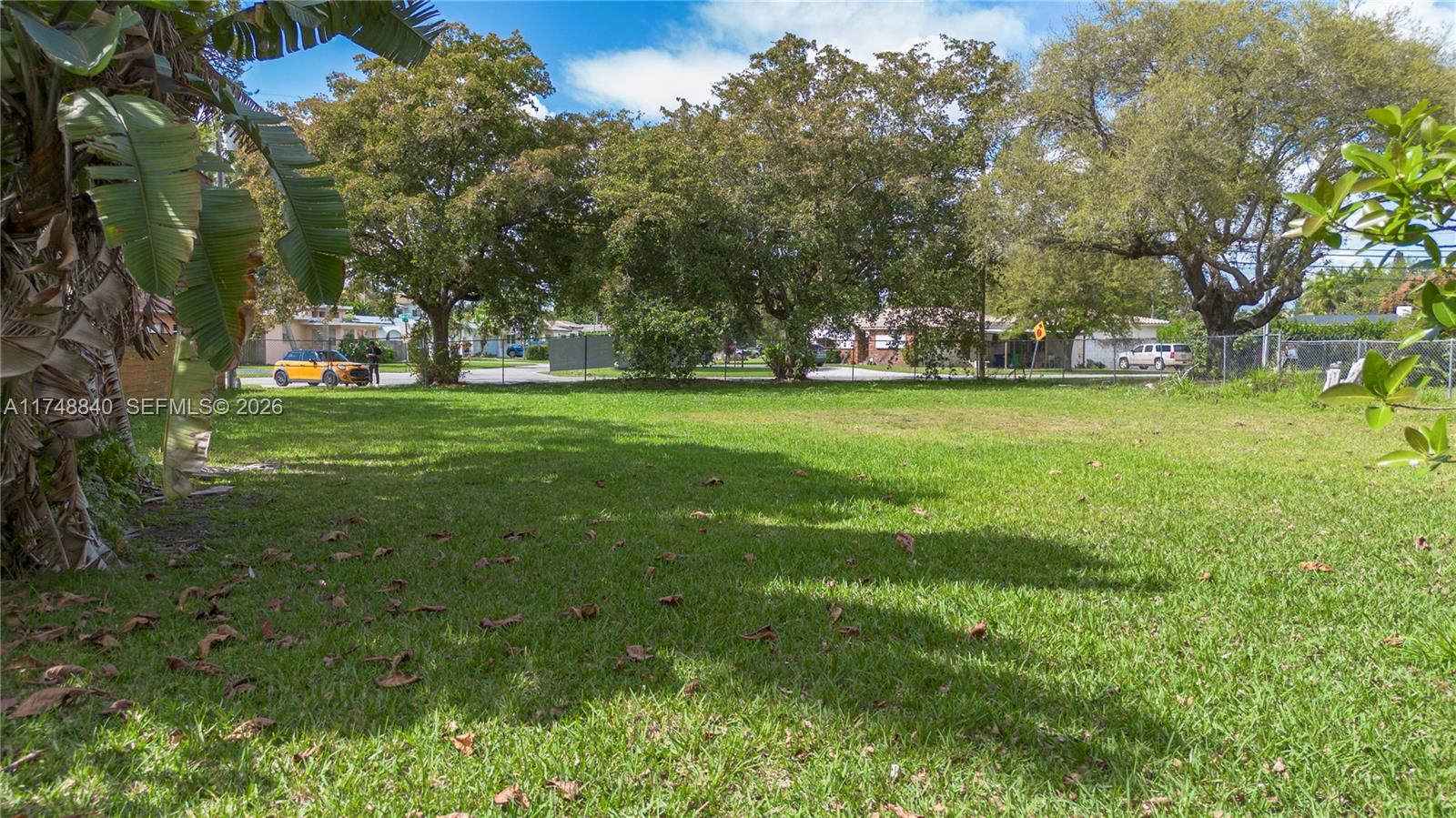 11701 West Biscayne Canal Road Miami, FL 33161 - Photo 11 of 14 a big yard with lots of green space and trees