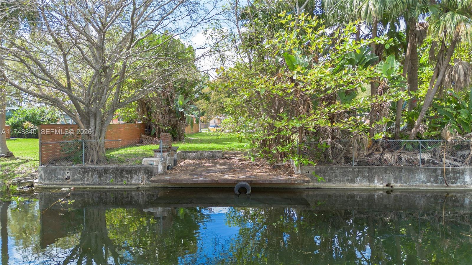 11701 West Biscayne Canal Road Miami, FL 33161 - Photo 12 of 14 a view of lake with a house in the background