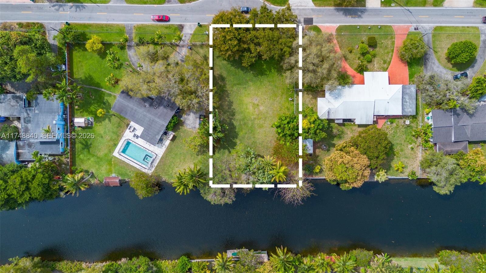 11701 West Biscayne Canal Road Miami, FL 33161 - Photo 2 of 14 an aerial view of a house with a yard and lake view