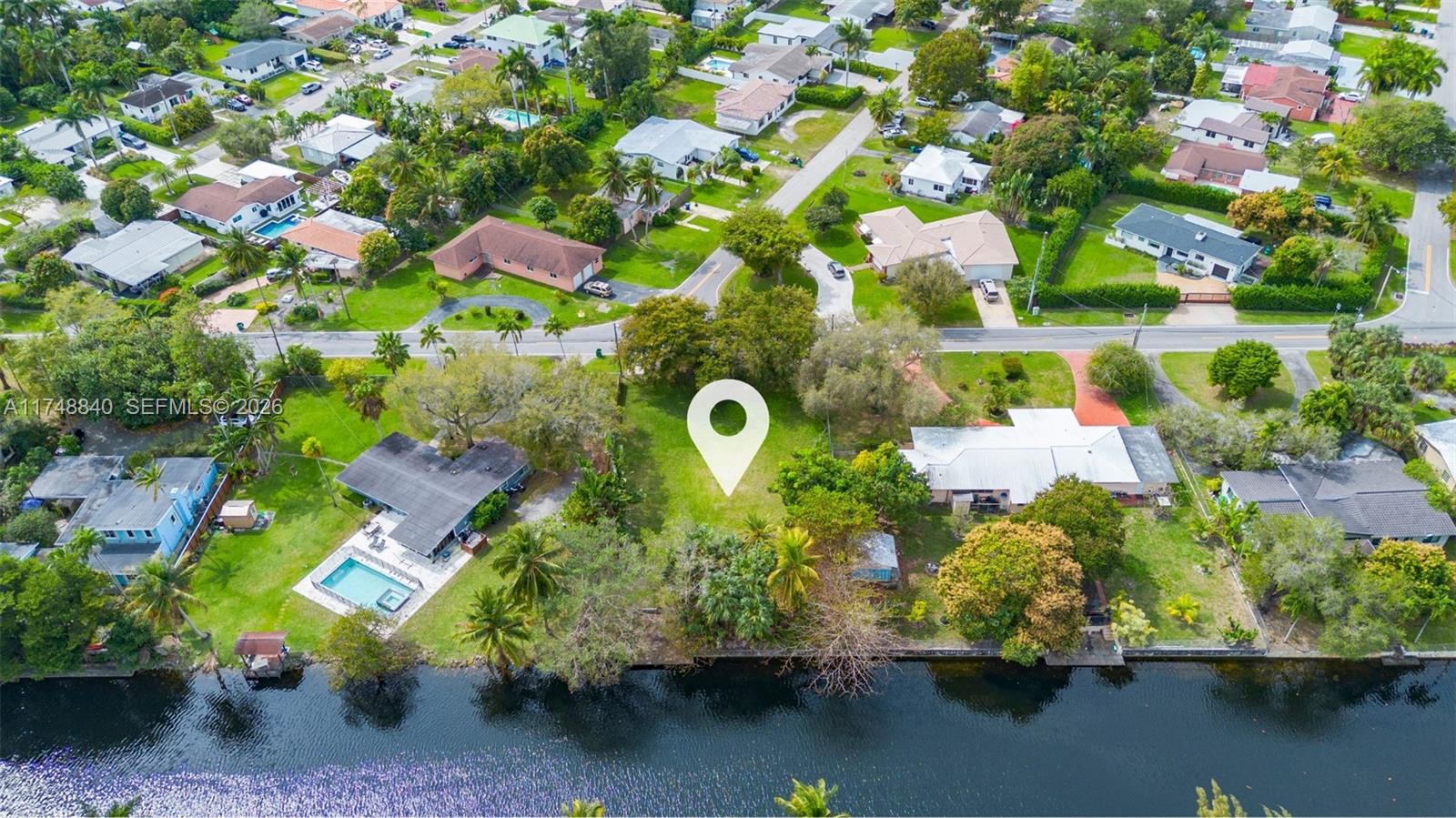 11701 West Biscayne Canal Road Miami, FL 33161 - Photo 3 of 14 a bird view of a house with a yard and lake view