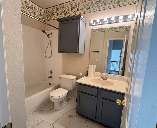 a spacious bathroom with a toilet sink and mirror