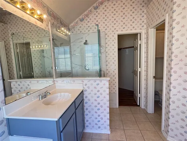 a bathroom with a sink a mirror and a shower