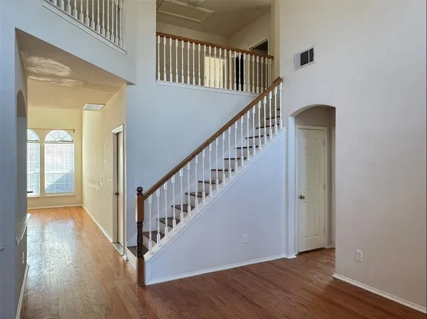 a view of an entryway with wooden floor