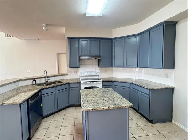 a kitchen with granite countertop cabinets and sink