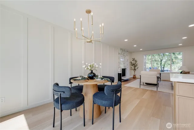 a dining room with furniture and large windows