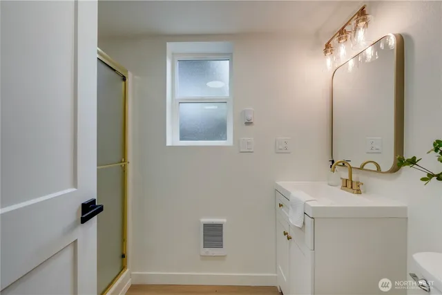 a bathroom with a glass shower door