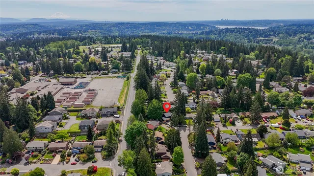 an aerial view of a house with outdoor space and street view