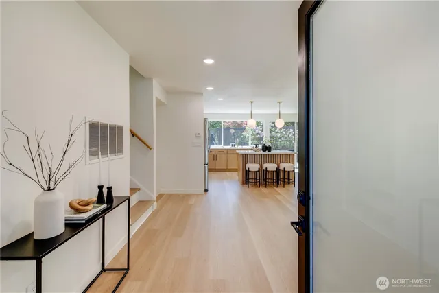 a view of living room kitchen with furniture and wooden floor