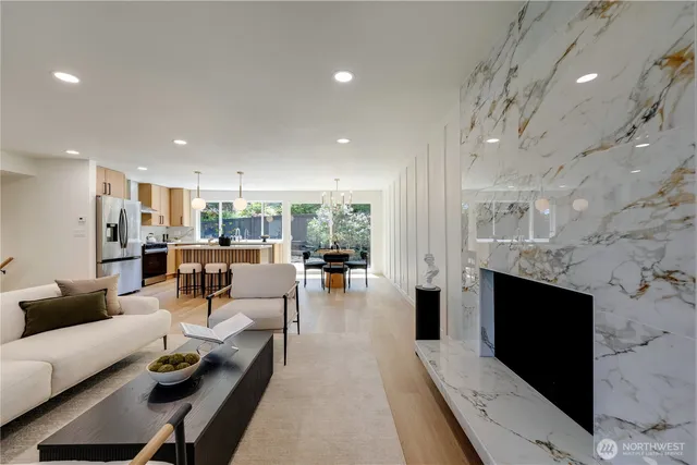 a dining room with furniture a chandelier and wooden floor