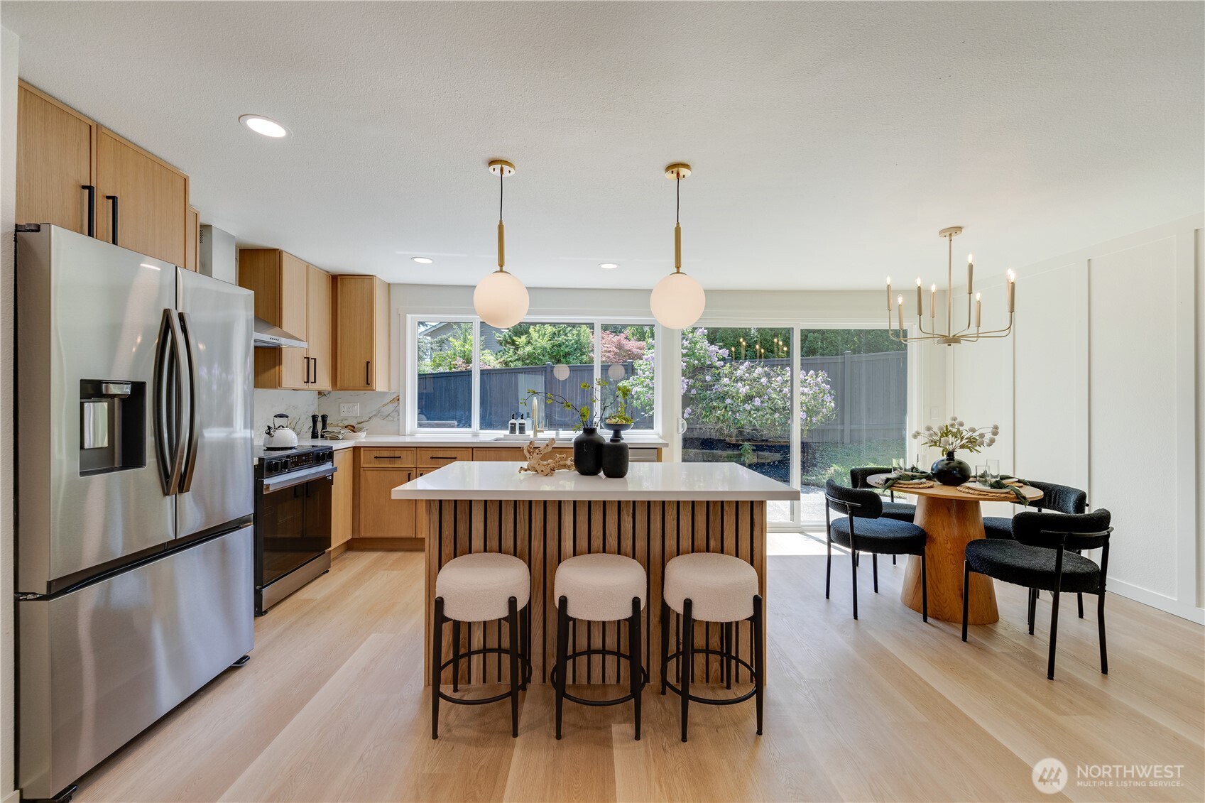 416 221st Street Southwest Bothell, WA 98021 - Photo 9 of 40 a dining room with furniture a chandelier and wooden floor