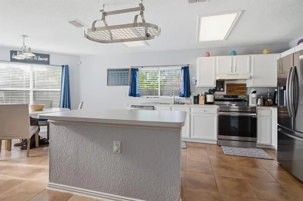 a kitchen with stainless steel appliances a stove sink and microwave