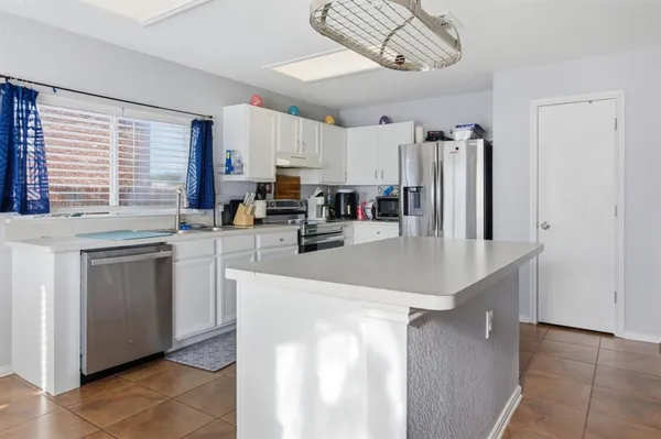 a kitchen with stainless steel appliances granite countertop a sink a stove and cabinets