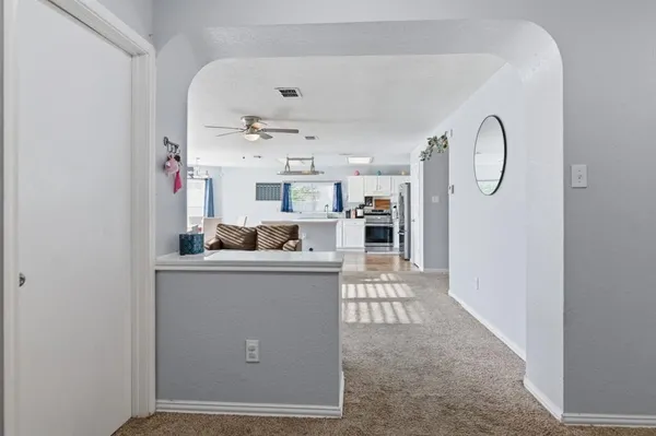 a living room with furniture a clock and white walls