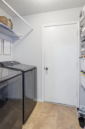 a bathroom with a granite countertop sink and a refrigerator