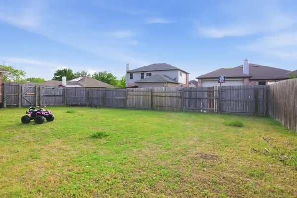 a view of a backyard with a garden and deck