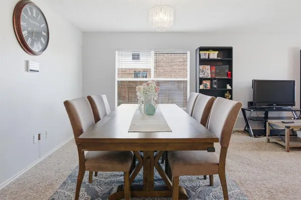 a view of a dining room with furniture and a potted plant