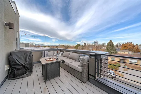 a view of a balcony with furniture and wooden floor