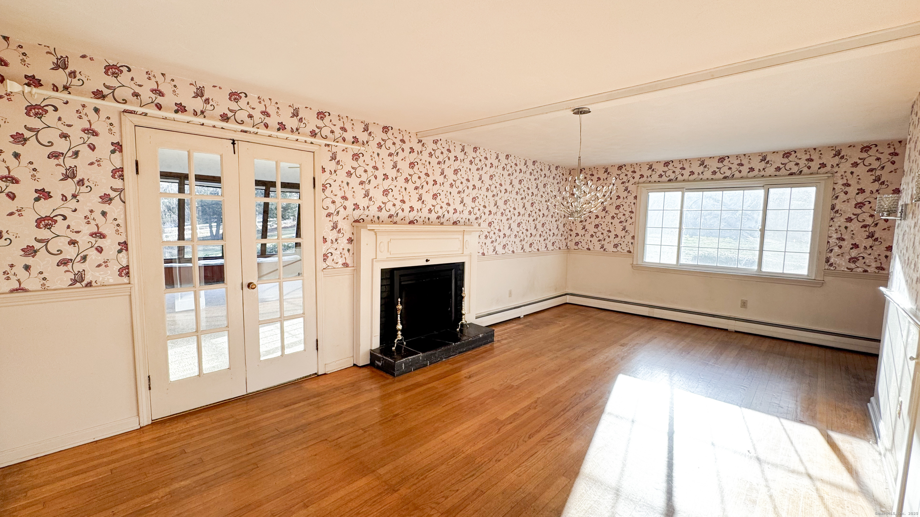 338 Main Street Hampton, CT 06247 - Photo 12 of 31 an empty room with windows and fireplace