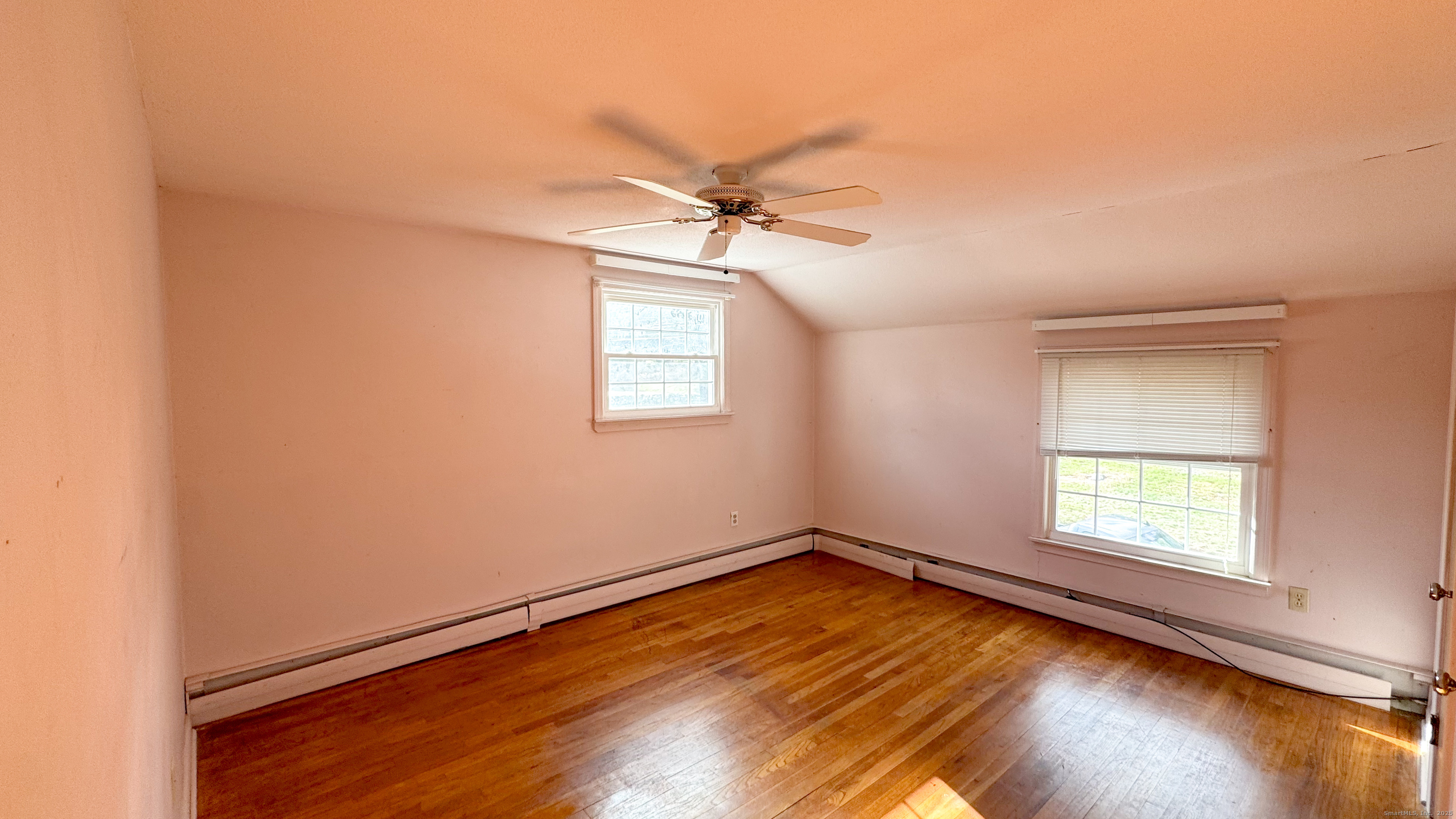 338 Main Street Hampton, CT 06247 - Photo 23 of 31 an empty room with windows and ceiling fan