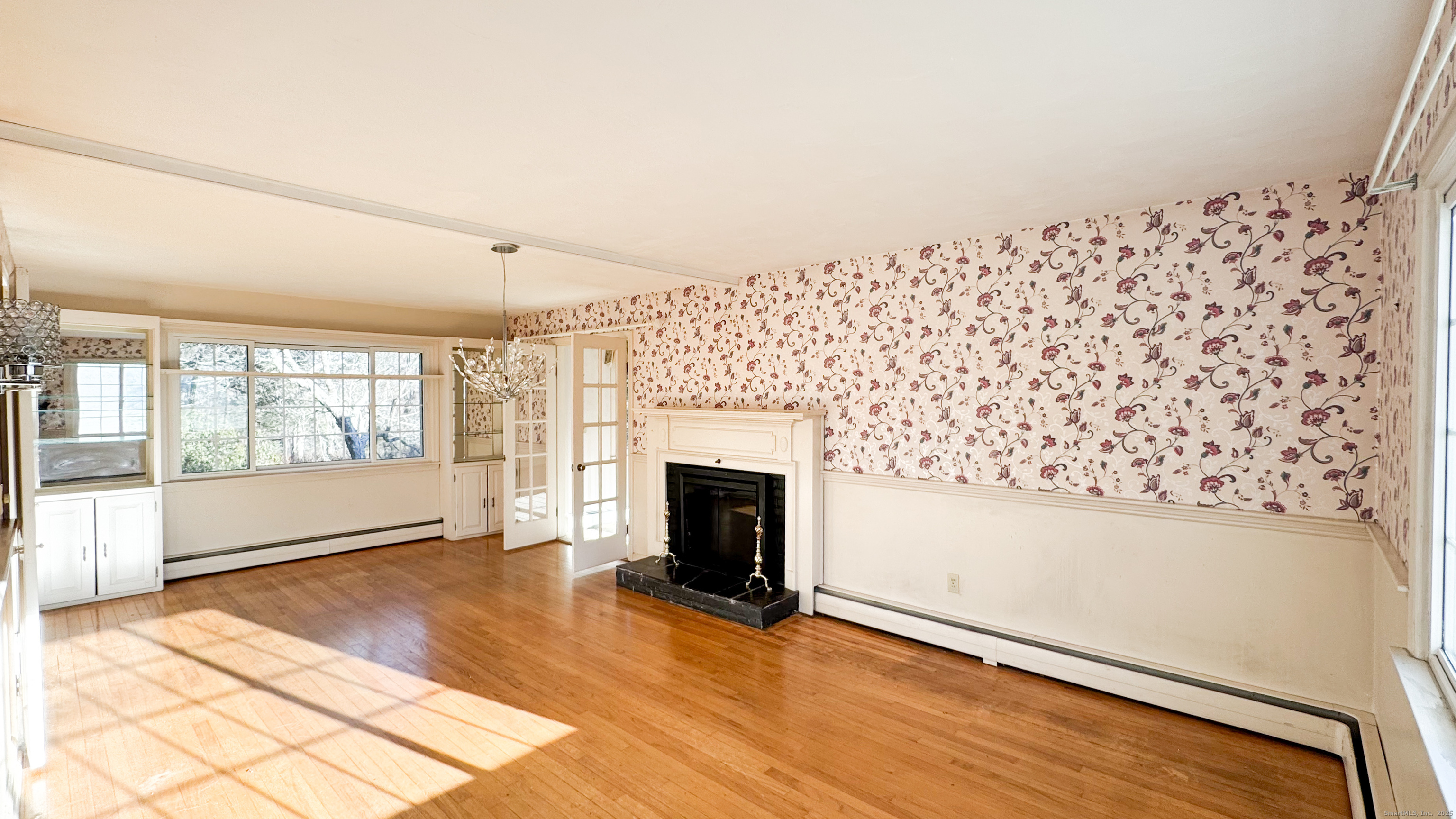 338 Main Street Hampton, CT 06247 - Photo 10 of 31 a view of an empty room with wooden floor and a fireplace