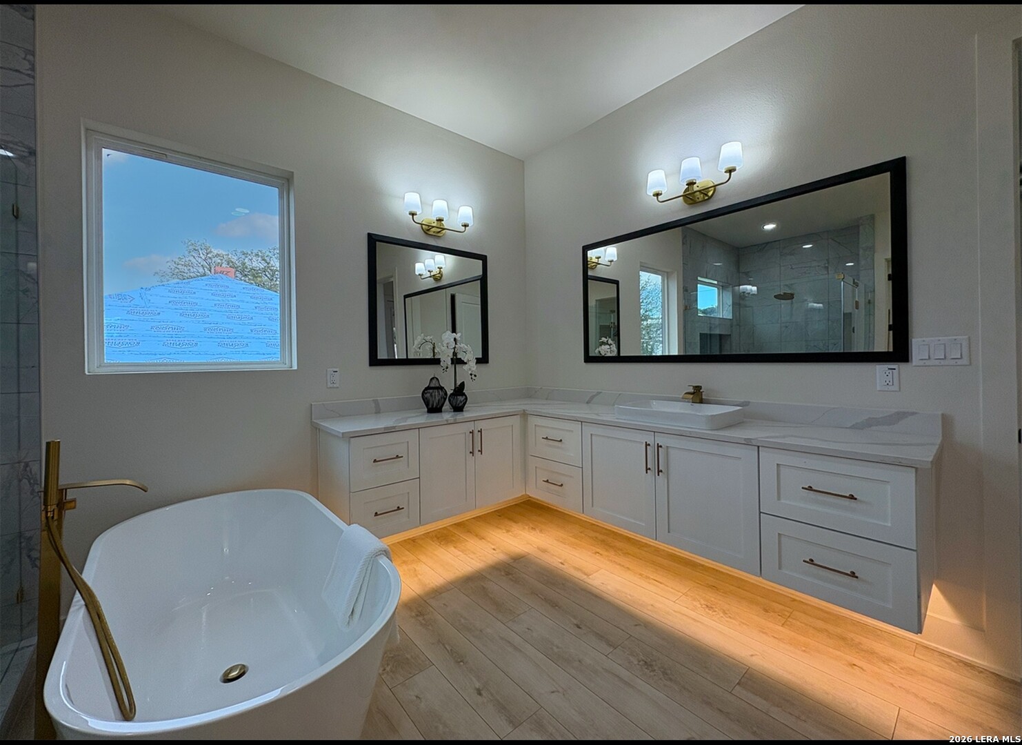11010 Nina Ridge San Antonio, TX 78255 - Photo 20 of 44 a bathroom with a sink a large mirror and a bathtub