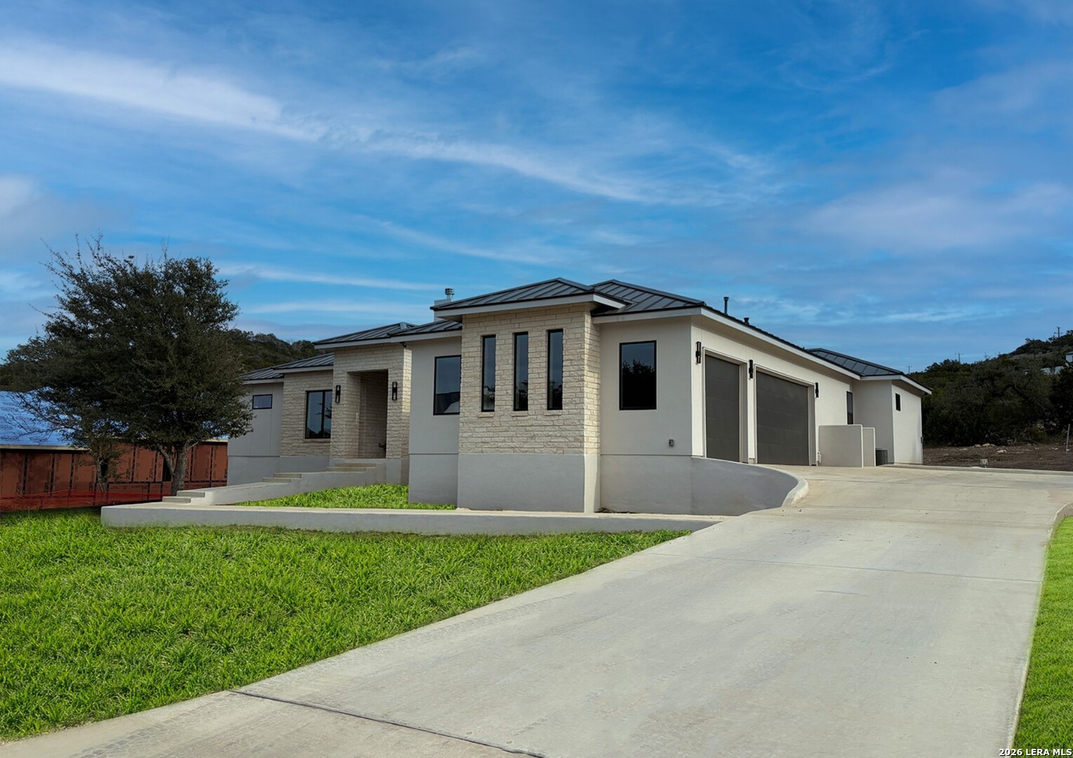 11010 Nina Ridge San Antonio, TX 78255 - Photo 2 of 44 a front view of house with yard and green space