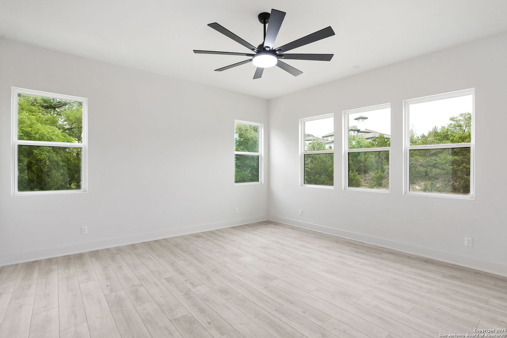 11010 Nina Ridge San Antonio, TX 78255 - Photo 28 of 44 a view of an empty room with wooden floor and a window