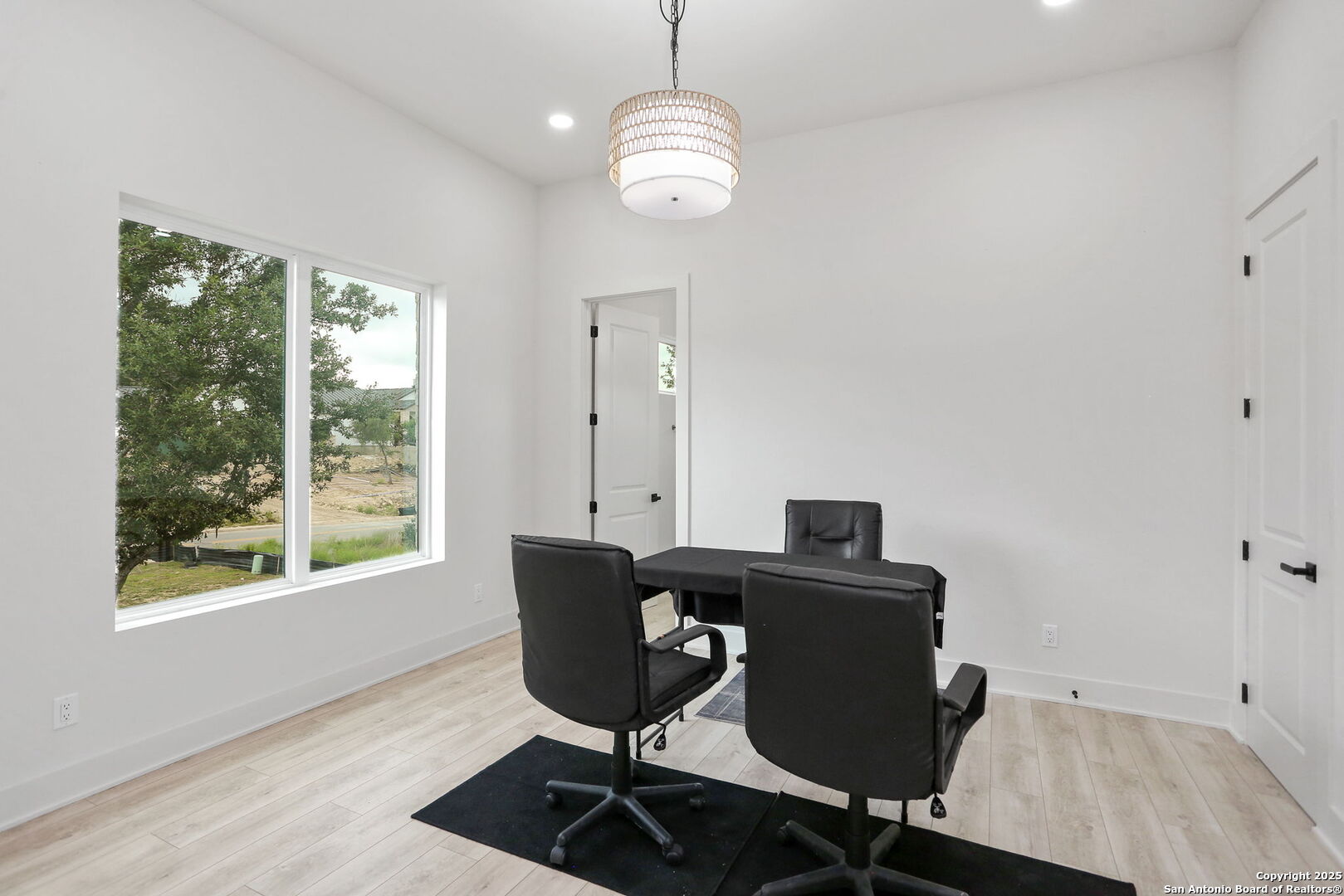 11010 Nina Ridge San Antonio, TX 78255 - Photo 3 of 44 a view of a workspace with furniture and a window