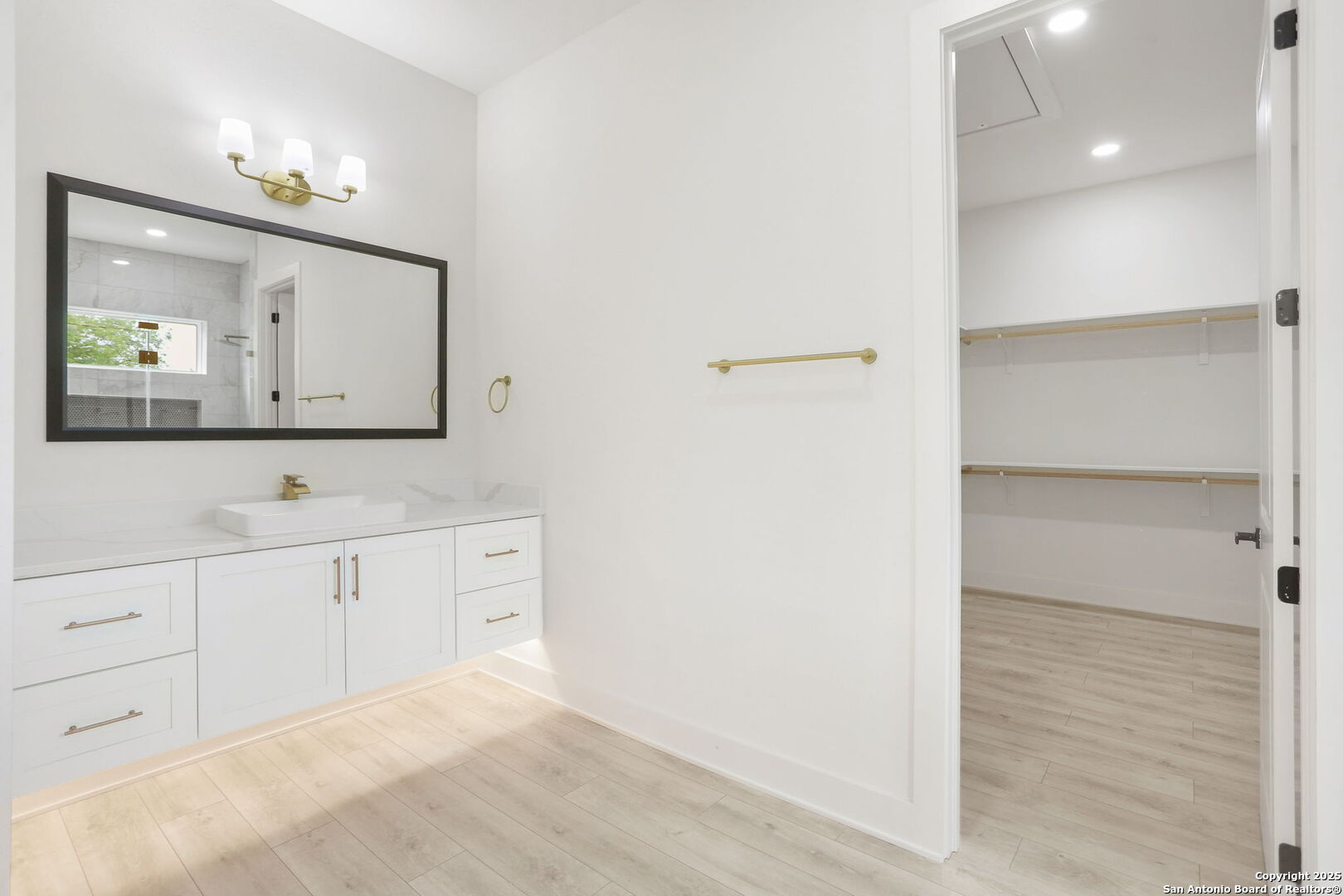 11010 Nina Ridge San Antonio, TX 78255 - Photo 32 of 44 a bathroom with a double vanity sink and a mirror