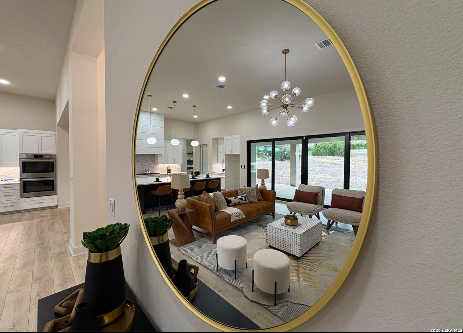 11010 Nina Ridge San Antonio, TX 78255 - Photo 7 of 44 a living room with furniture and a chandelier