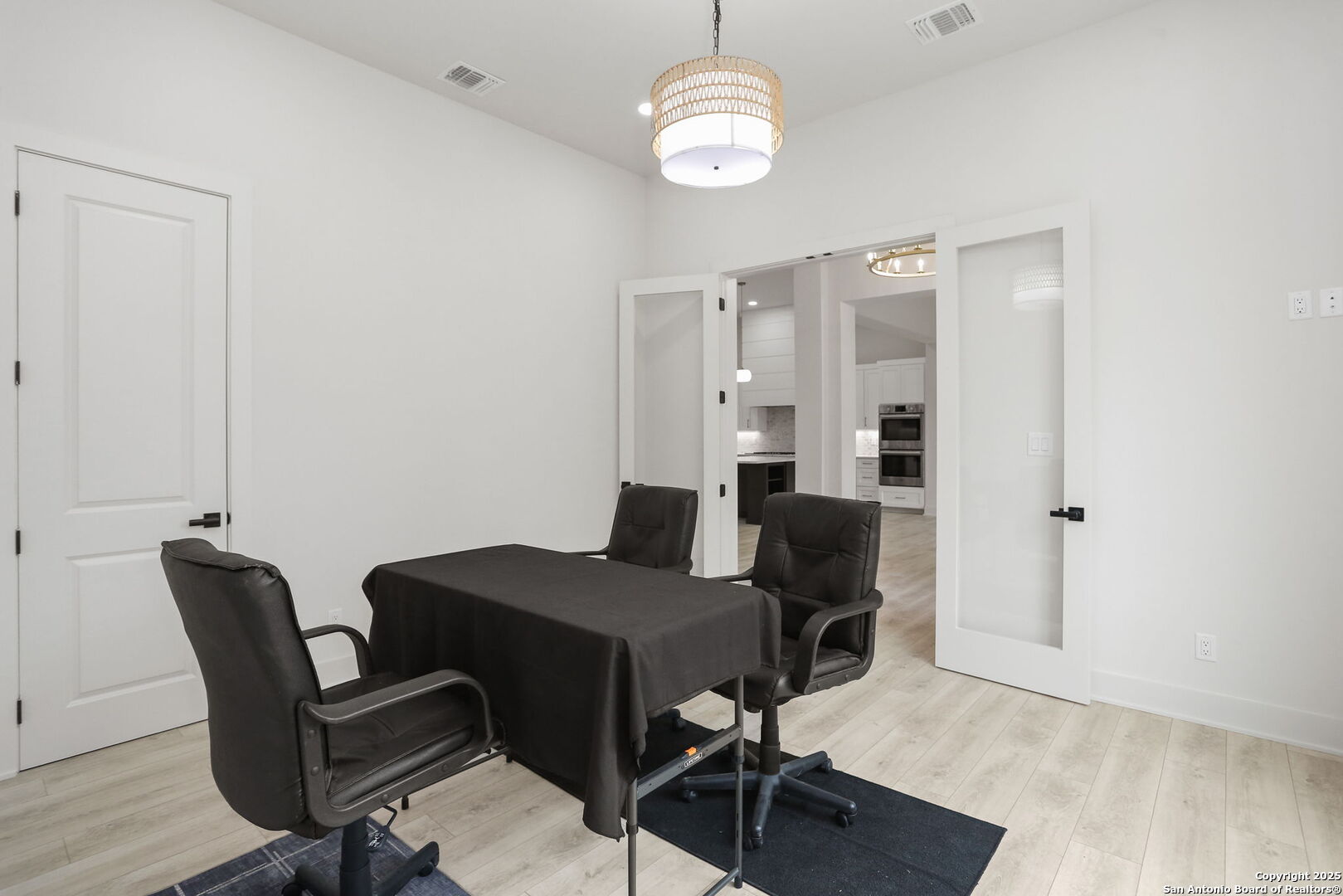 11010 Nina Ridge San Antonio, TX 78255 - Photo 8 of 44 a view of a dining room with furniture and wooden floor
