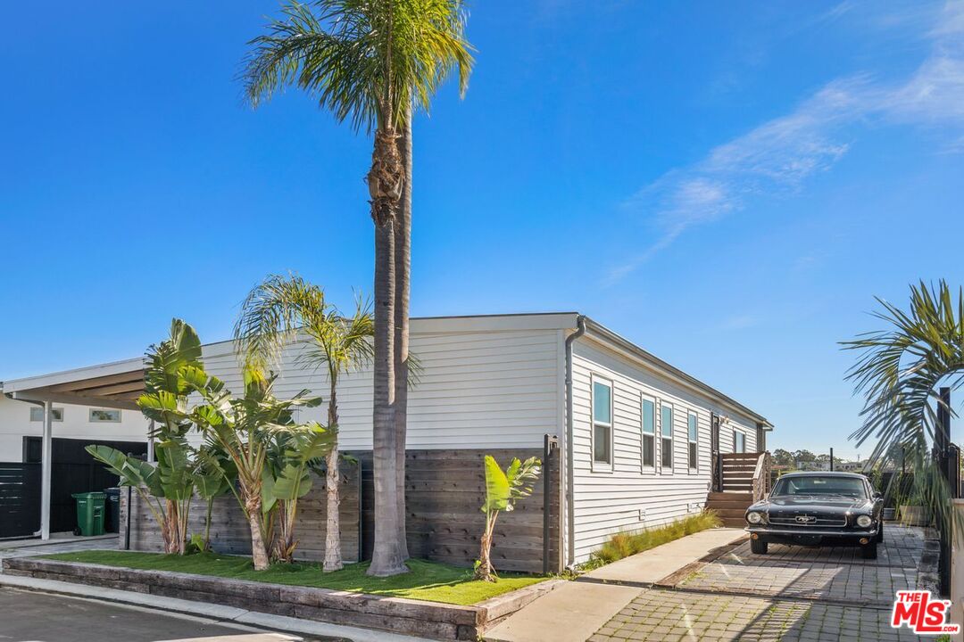 29500 Heathercliff Road, Unit SPC 103 Malibu, CA 90265 - Photo 1 of 15 a front view of a house with garden