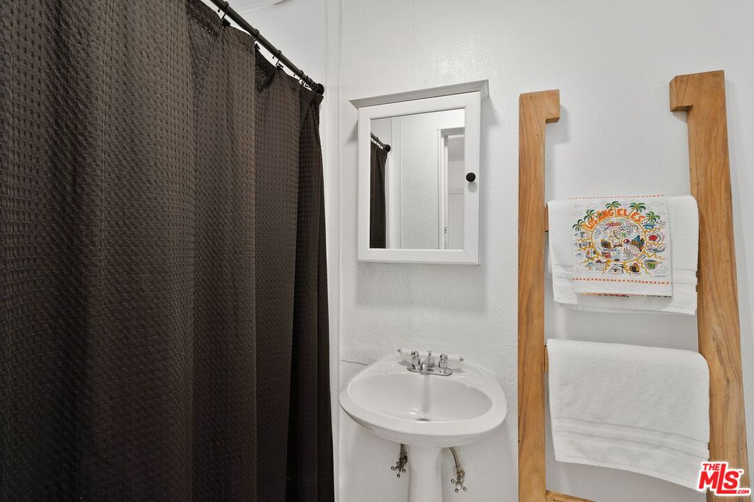 29500 Heathercliff Road, Unit SPC 103 Malibu, CA 90265 - Photo 11 of 15 a bathroom with a sink and mirror