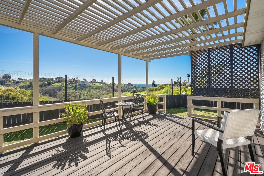 29500 Heathercliff Road, Unit SPC 103 Malibu, CA 90265 - Photo 12 of 15 a roof deck with table and chairs
