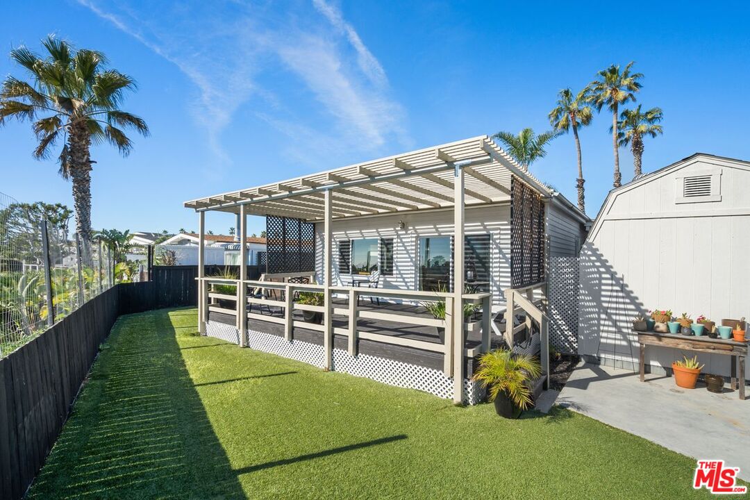 29500 Heathercliff Road, Unit SPC 103 Malibu, CA 90265 - Photo 13 of 15 a view of a house with backyard and sitting area