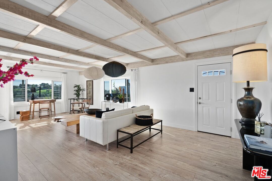 29500 Heathercliff Road, Unit SPC 103 Malibu, CA 90265 - Photo 2 of 15 a living room with furniture and a large window